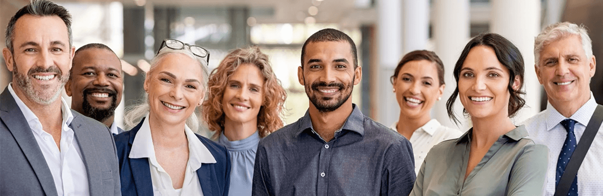 A group of professionals standing next to each other, smiling
