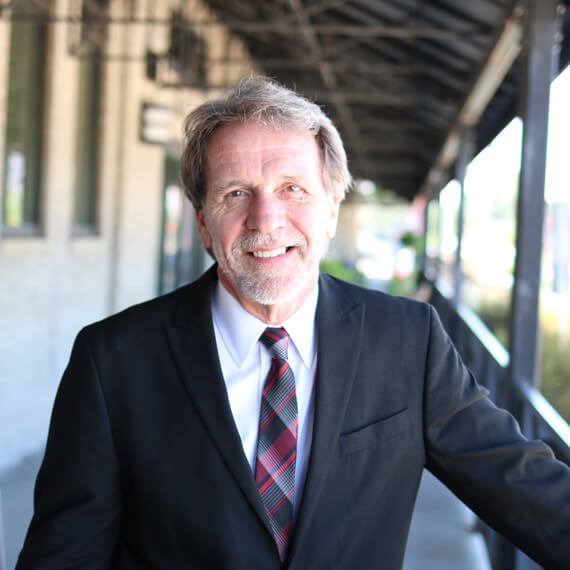 a male in a dark grey suit