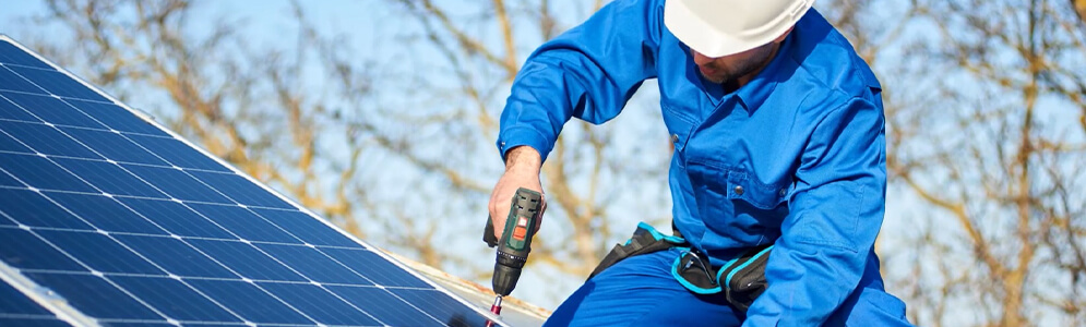 A male on top of a solar panel