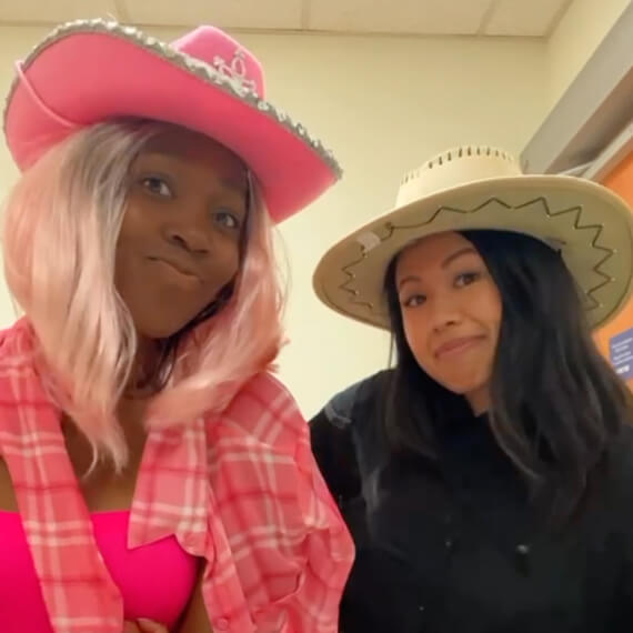 Two females dressed as Ken and Barbie Halloween costumes