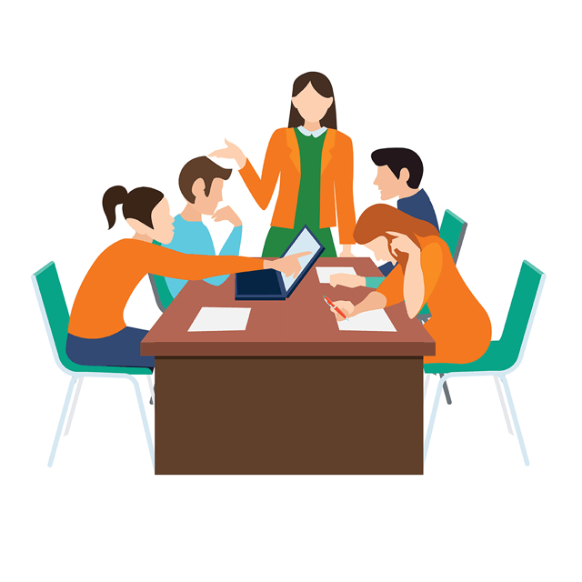 teacher at table with students sitting