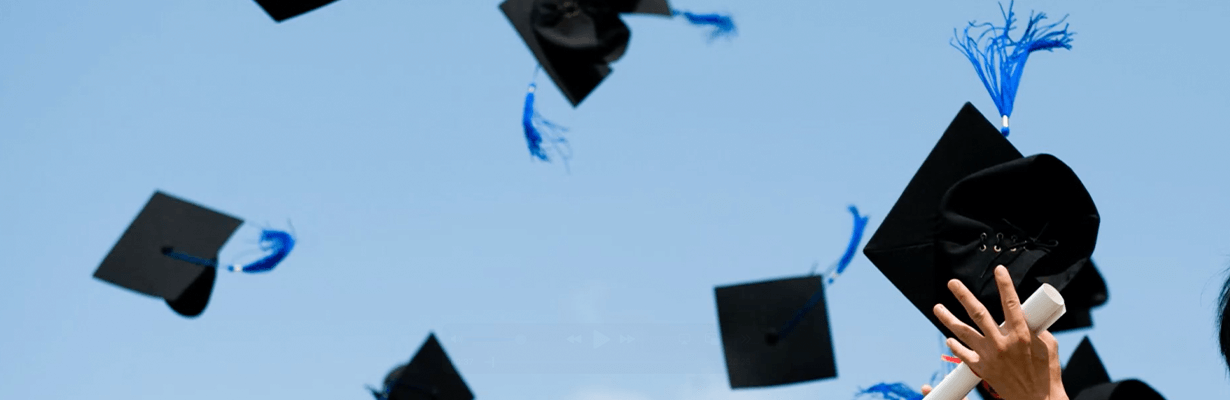 Graduation caps being thrown in the air