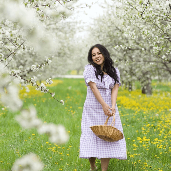 A female wearing a purple and white gingham dress.